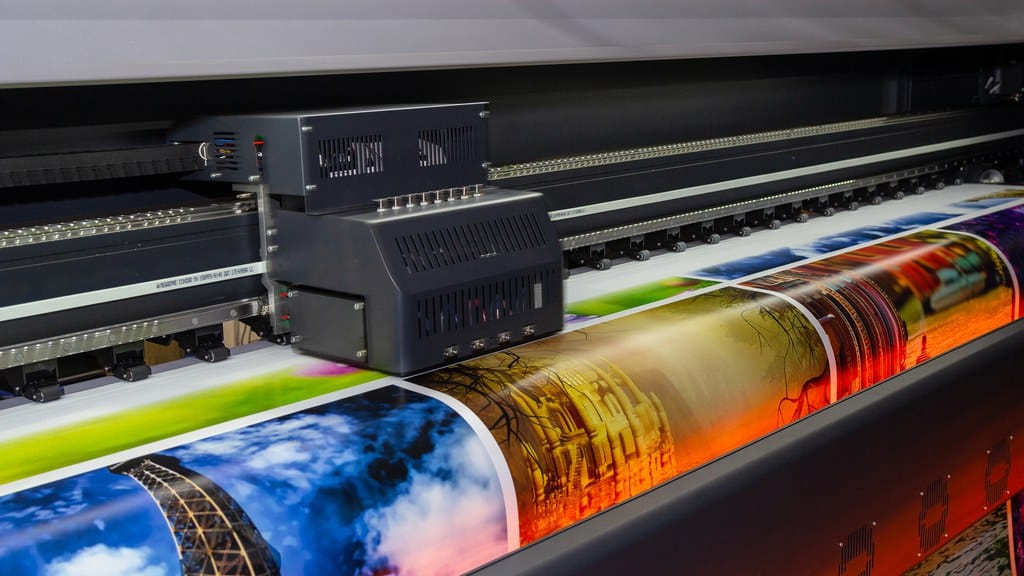 An industrial digital vinyl printing machine creating several designs on the same vinyl sheet